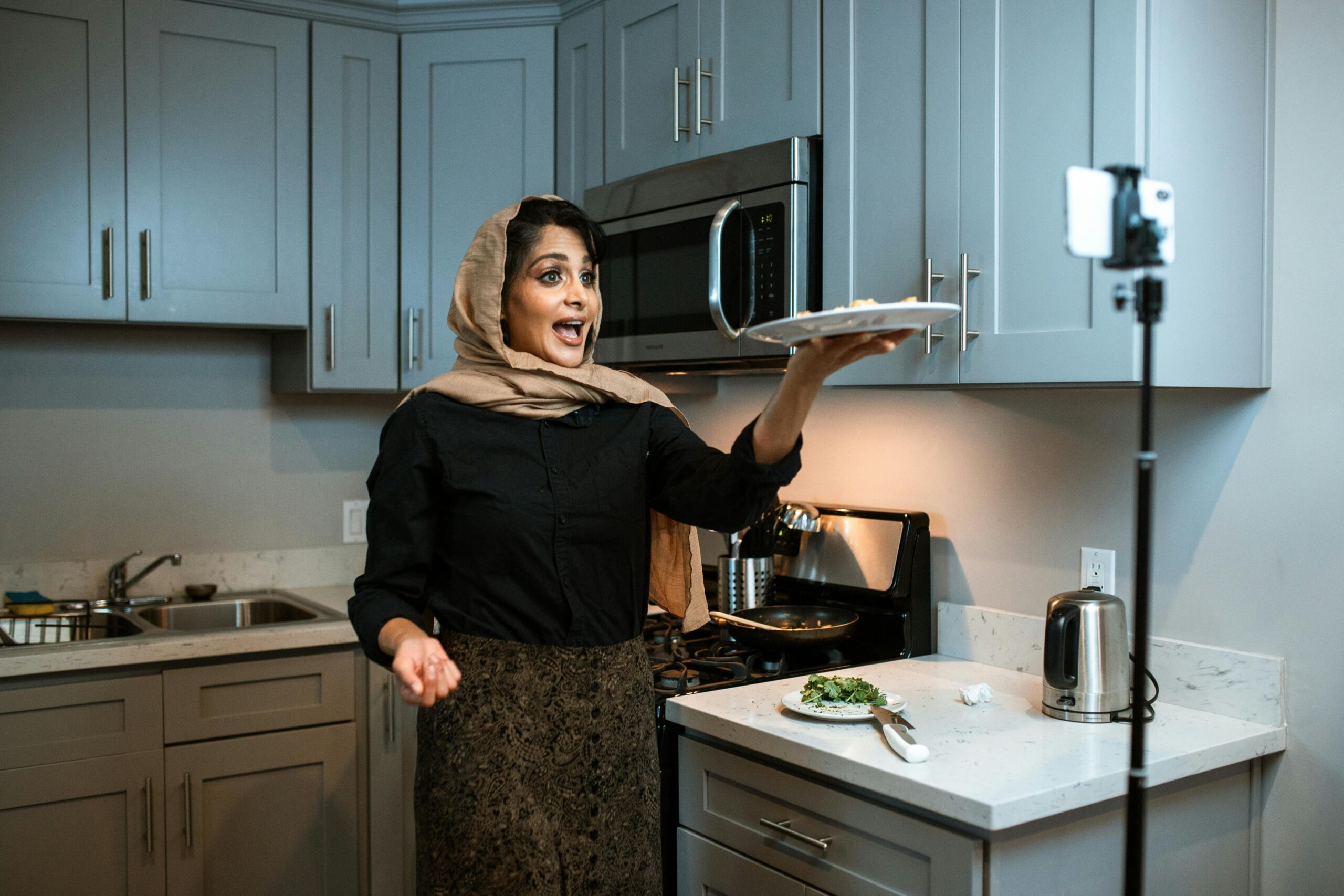 an arabic woman filming herself cooking